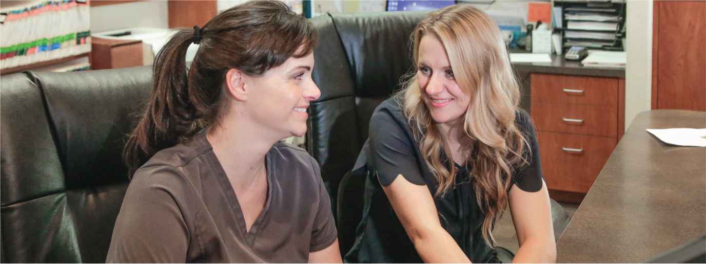image of two girls doing the 5 step dental software training